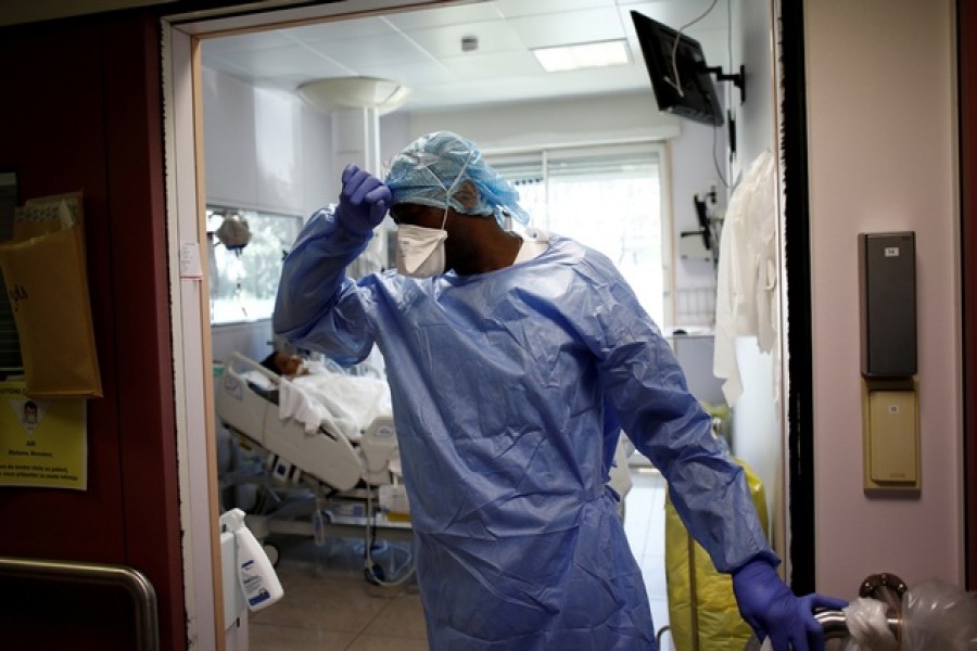 Medical staff, wearing protective suits and face masks, work at the intensive care unit for coronavirus disease (COVID-19) patients at Ambroise Pare clinic in Neuilly-sur-Seine near Paris, as the spread of the coronavirus disease continues in France, April 1, 2020. Reuters