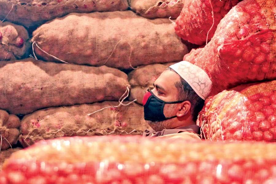 A wholesaler takes a nap at Karwan Bazar in the city on Thursday in absence of customers as the demand has sagged amid the coronavirus scare — FE photo