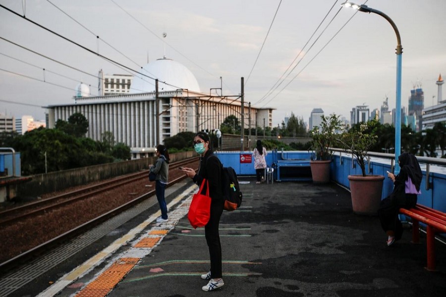 A passenger wearing her protective face mask waits for her commuter train at a station amid the spread of coronavirus disease (COVID-19) outbreak in Jakarta, Indonesia, April 02, 2020. — Reuters