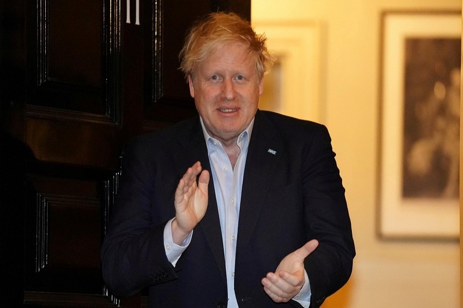 Britain's prime minister Boris Johnson applauds in support of the NHS during Clap for our Carers, outside 11 Downing Street in London, Britain April 2, 2020. — Pippa Fowles/10 Downing Street/Handout via Reuters