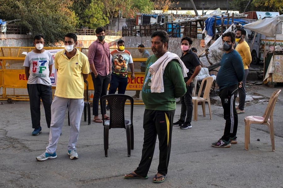Residents stand guard next to the barricades which they have used for blocking the road connecting to Nizamuddin area where hundreds were taken away to be quarantined amid coronavirus disease (COVID-19) fears, in New Delhi, India, April 01, 2020. — Reuters