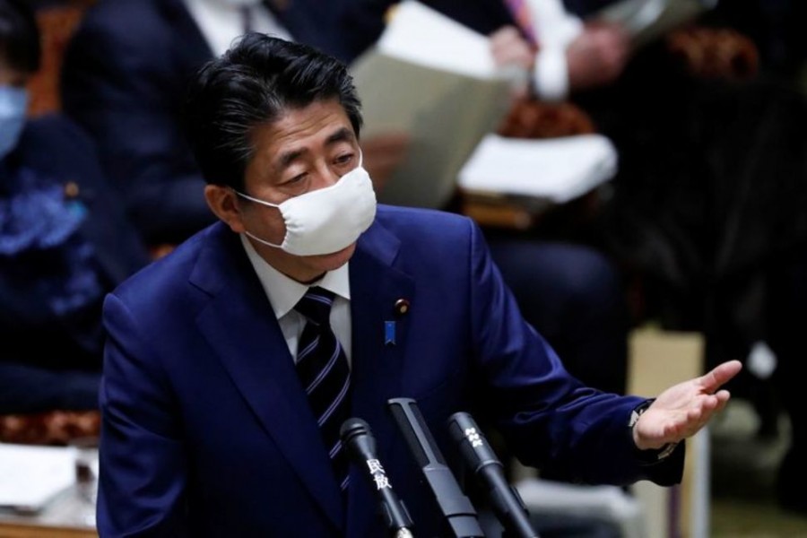 Japan's Prime Minister Shinzo Abe wears a protective face mask as he attends an upper house parliamentary session, following an outbreak of the coronavirus disease (COVID-19), in Tokyo, Japan April 1, 2020. REUTERS/Issei Kato
