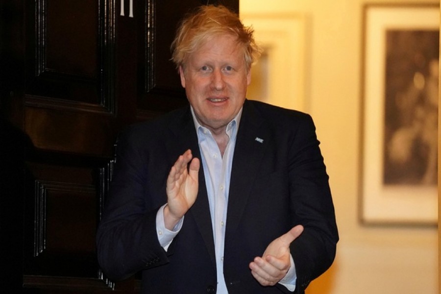 Britain's Prime Minister Boris Johnson applauds in support of the NHS during Clap for our Carers, outside 11 Downing Street in London, Britain, April 02, 2020. — Pippa Fowles/10 Downing Street/Handout via Reuters