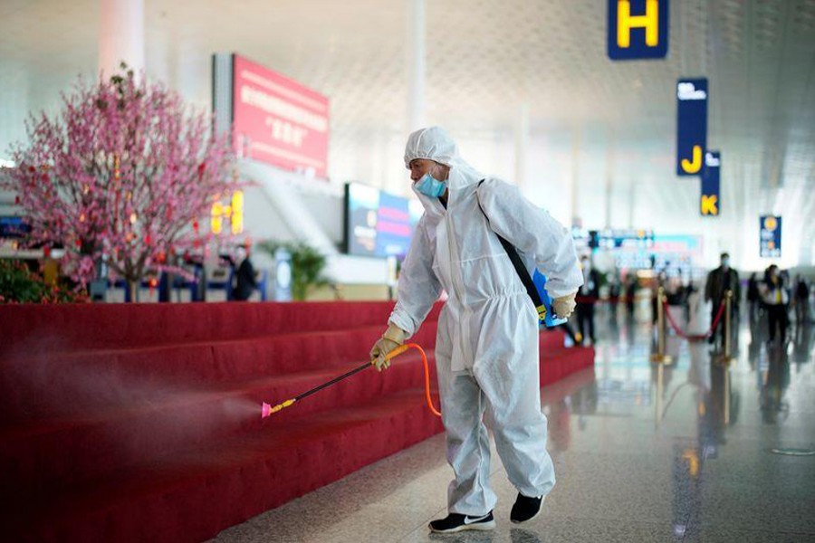A worker in protective suit disinfects the Wuhan Tianhe International Airport after travel restrictions to leave Wuhan, the capital of Hubei province and China's epicentre of the novel coronavirus disease (COVID-19) outbreak, were lifted on April 8, 2020 — REUTERS photo