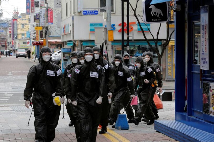 South Korean soldiers in protective gear make their way while they disinfect buildings downtown, following the rise in confirmed cases of coronavirus disease (COVID-19) in Daegu, South Korea on March 15, 2020 — Reuters/Files