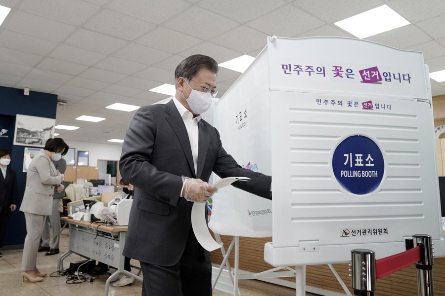 South Korean President Moon Jae-in wearing a mask and a plastic gloves to prevent contracting the coronavirus disease (COVID-19), arrives to cast his absentee ballot at a polling station for parliamentary election in Seoul, South Korea on April 10, 2020  — Yonhap via REUTERS