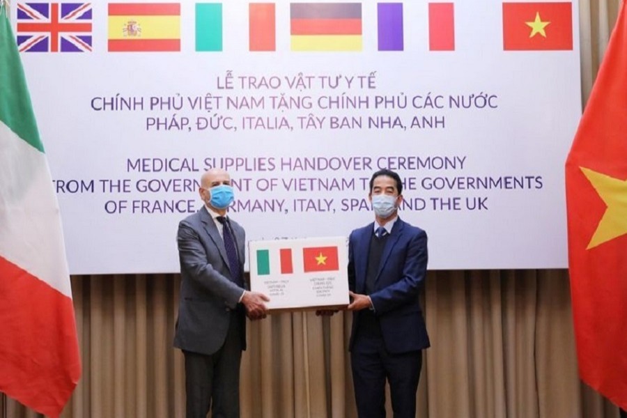 Vietnam's deputy foreign minister To Anh Dung hands a box of protective masks to Italy's ambassador to Vietnam Antonio Alessandro during a handover ceremony as Vietnam donates medical supplies to France, Germany, Italy, Spain and Britain, amid the global coronavirus disease (COVID-19) outbreak, in Hanoi, Vietnam April 07, 2020. —Lam Khanh/VNA via Reuters
