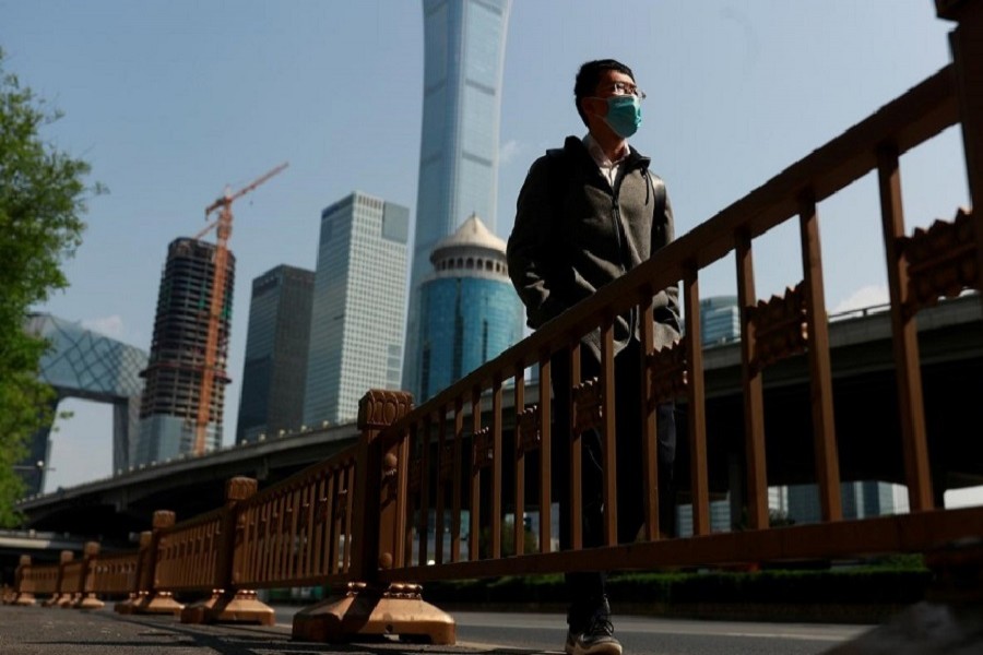 A man walks by Beijing's Central Business District during morning rush hour as the spread of the new coronavirus disease (COVID-19) continues in China, April 17, 2020. — Reuters
