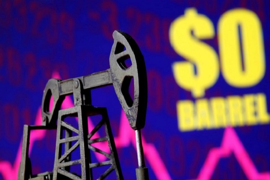 A 3D-printed oil pump jack is seen in front of a displayed stock graph and "$0 Barrel" words in this illustration picture, April 20, 2020. — Reuters/Illustration