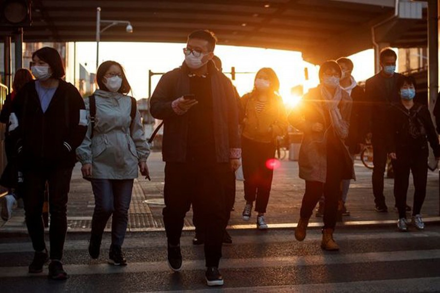 People wear protective masks as they leave work during evening rush hour in Beijing as the spread of the novel coronavirus disease (COVID-19) continues, China on April 20, 2020 — Reuters photo