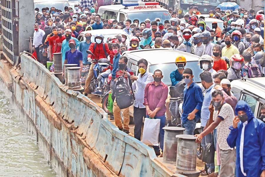 A ferry carrying Dhaka-bound passengers docks at Mawa Ghat in Munshiganj on Sunday as the rush for return to the capital city begins with a number of garment factories reopening to a limited extent —Photo: Collected