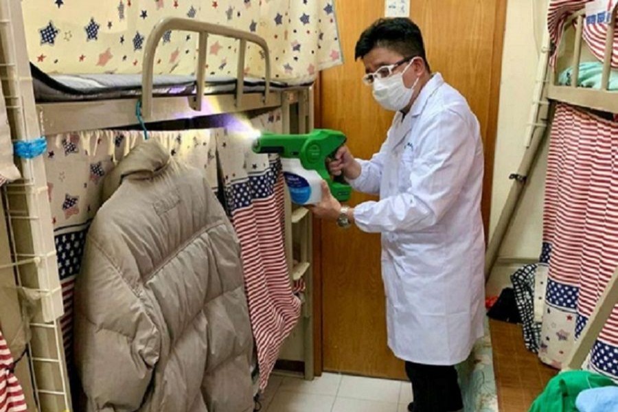 A man demonstrating how to spray MAP-1, an antimicrobial coating that a team of university researchers claimed to be effective in killing virus, bacteria and spore, at a bedspace apartment in Hong Kong, China April 21, 2020. –Reuters Photo