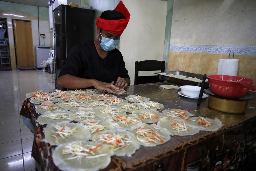 An online Ramadan bazaar trader wraps "Popiah" spring rolls at his home, during the movement control order due to the outbreak of the coronavirus disease (COVID-19), in Sungai Buloh, Malaysia on April 11, 2020 — Reuters photo