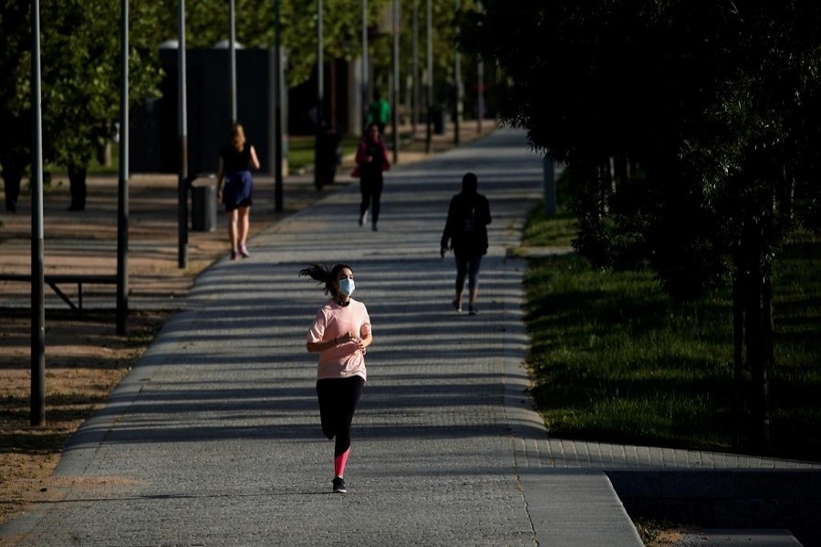 A woman wearing a protective face mask runs in Madrid Rio park, during the hours allowed for individual exercise, for the first time since the lockdown was announced on March 14, amid the coronavirus disease (COVID-19) outbreak, in Madrid, Spain, May 2, 2020. — Reuters