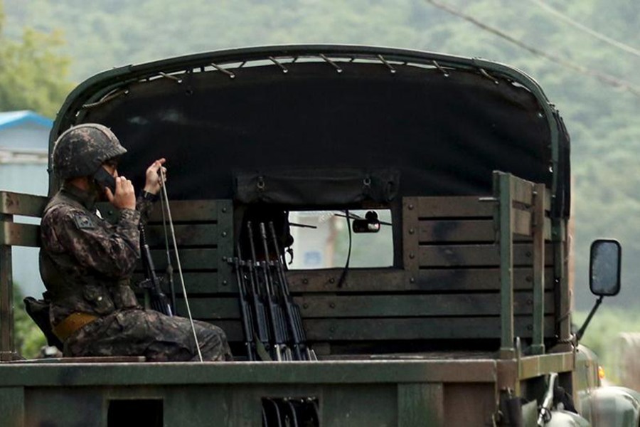 A South Korean soldier talks on a radio as he sits on a military vehicle at the demilitarised zone separating the two Koreas in Yeoncheon, South Korea on August 20, 2015 — Yonhap via REUTERS/Files
