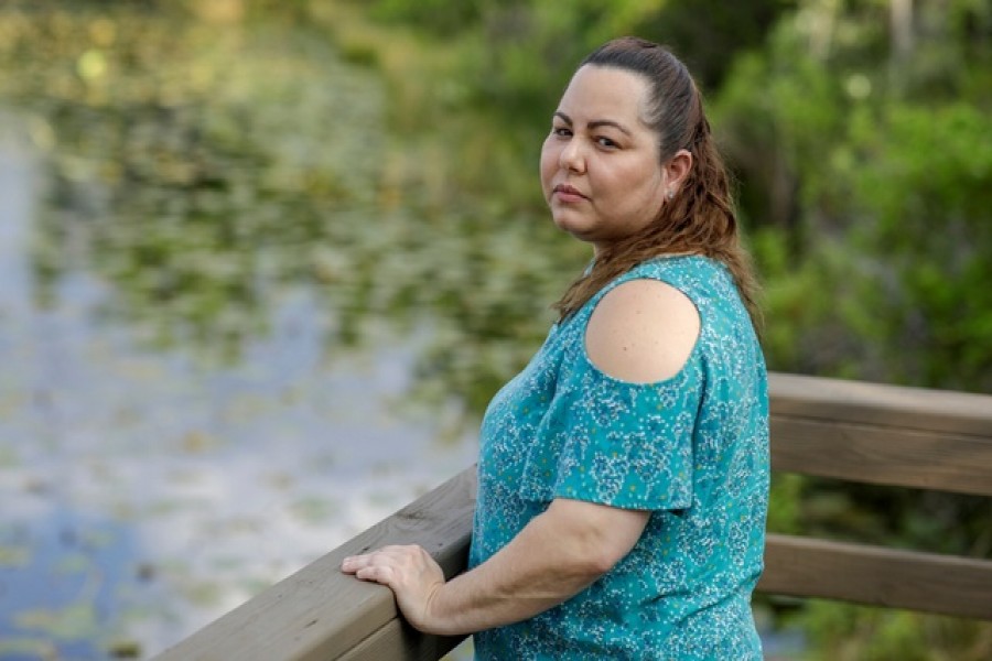 Claudia Alejandra, 37, furloughed from her job at the makeup counter at Macy's amid the coronavirus disease (COVID-19), poses for a portrait near a lake in Orlando, Florida, US, March 06, 2020. – Reuters/Files