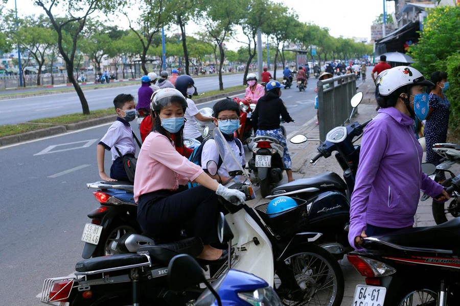 Do Thi Kim Dung, 41, and her son Nguyen Dinh Thanh, 11, get to the primary school for their fisrt day after the government eased nationwide lockdown during the coronavirus disease (COVID-19) outbreak in Ho Chi Minh, Vietnam on May 8, 2020 — Reuters photo