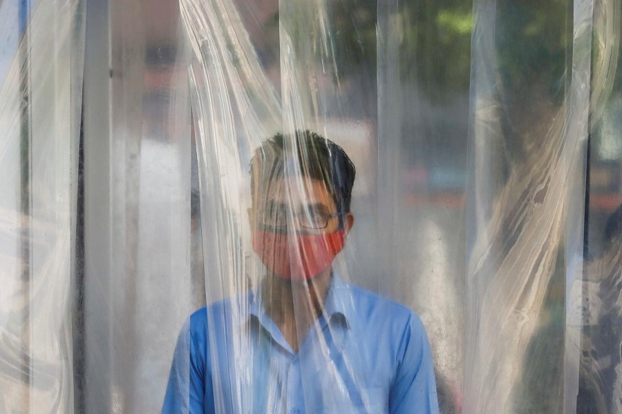 A man wears a protective mask as he gets sanitised before entering a shopping mall, after Pakistan started easing the lockdown restrictions, amid the coronavirus disease (COVID-19) outbreak, in Karachi, Pakistan, May 18, 2020. — Reuters