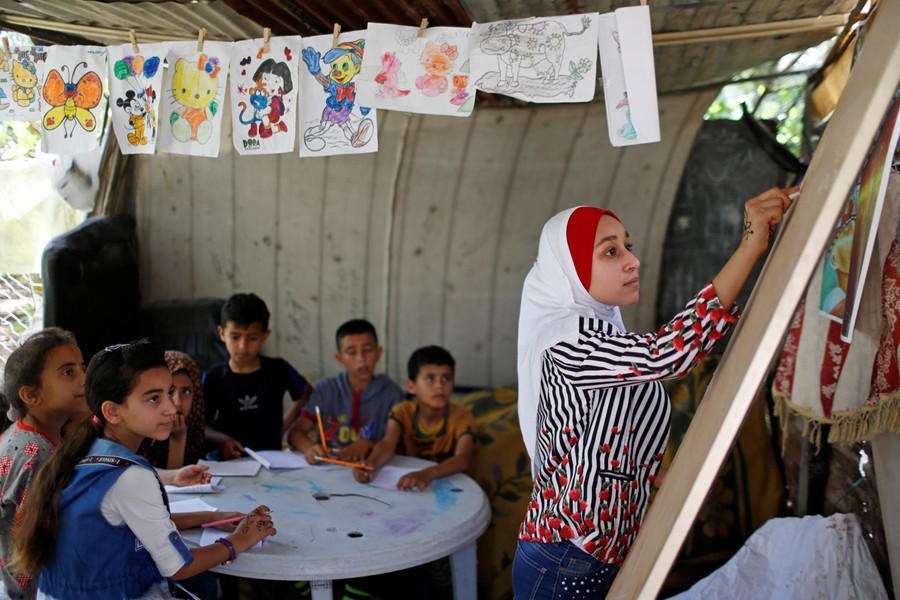 A Palestinian school girl Fajr Hmaid, 13, teaches her neighbours' children an Arabic language lesson as schools are shut due to the coronavirus disease (COVID-19) restrictions, at her family house in Gaza on May 19, 2020 — Reuters photo