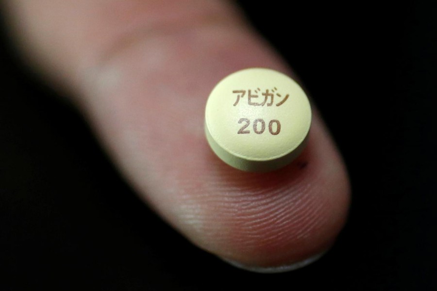 A tablet of Avigan (generic name: favipiravir) approved as an anti-influenza drug in Japan and developed by drug maker Toyama Chemical Co, a subsidiary of Fujifilm Holdings Co is displayed during a photo opportunity at Fujifilm's headquarters in Tokyo on October 22, 2014 — Reuters/Files