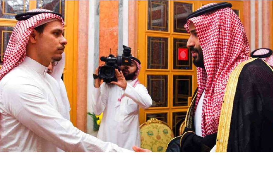Salah Khashoggi, left, a son of Jamal Khashoggi, shakes hands with Saudi Crown Prince Mohammed bin Salman in Riyadh, Saudi Arabia. (Saudi Press Agency via AP, File)