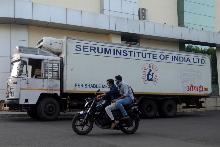 Men ride on a motorbike past a supply truck of India's Serum Institute, the world's largest maker of vaccines, which is working on a vaccine against the coronavirus disease (COVID-19) in Pune, India, May 18, 2020. — Reuters