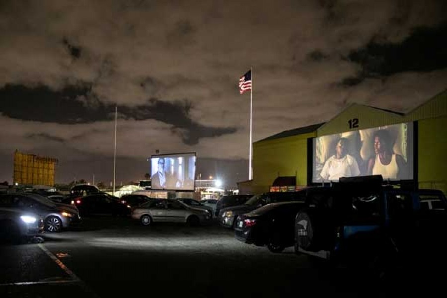 People inside their cars watch a movie at a drive-in theatre while keeping social distancing following the outbreak of the coronavirus disease (COVID-19) in Fort Lauderdale, Florida, US, Mar 28, 2020. REUTERS
