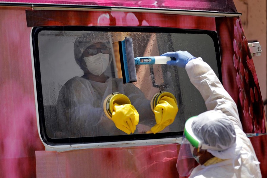 A medical worker sits inside a mobile test van for the coronavirus disease (COVID-19) after she collected swabs from people to test, on the outskirts of Ahmedabad, India on April 27, 2020 — Reuters/Files
