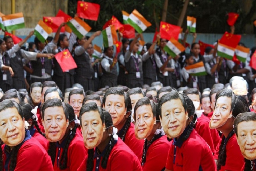 File photo of students wearing masks of China's President Xi Jinping as others wave national flags of India and China, ahead of the informal summit with India’s Prime Minister Narendra Modi, at a school in Chennai, India, October 10, 2019. — Reuters