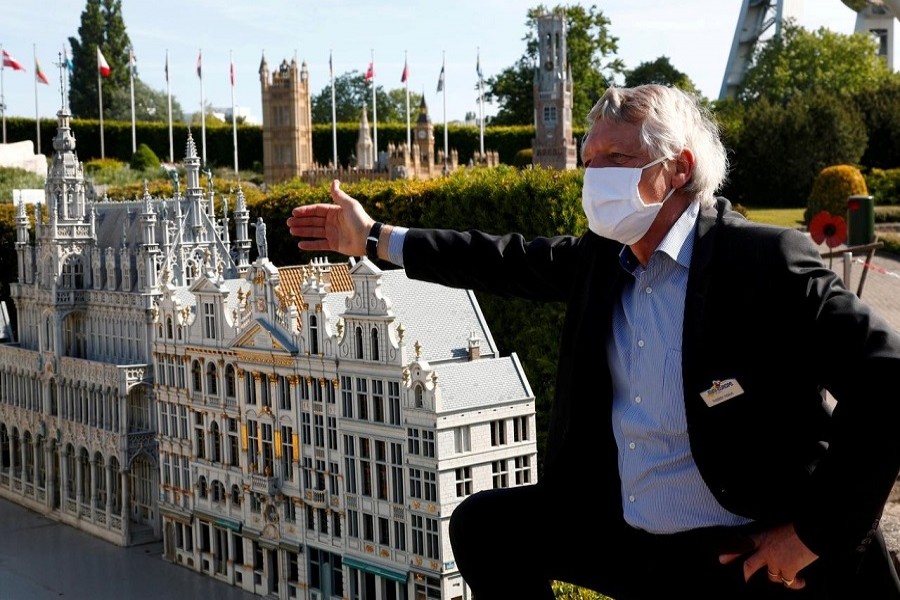 Mini-Europe Director Thierry Meeus wearing a protective mask talks to children during the reopening of 'mini-Europe' theme park where people can wonder across small scale models of European capitals landmarks as Belgium began easing lockdown restrictions amid the coronavirus disease (COVID-19) outbreak, in Brussels, Belgium, May 18, 2020. — Reuters/Files