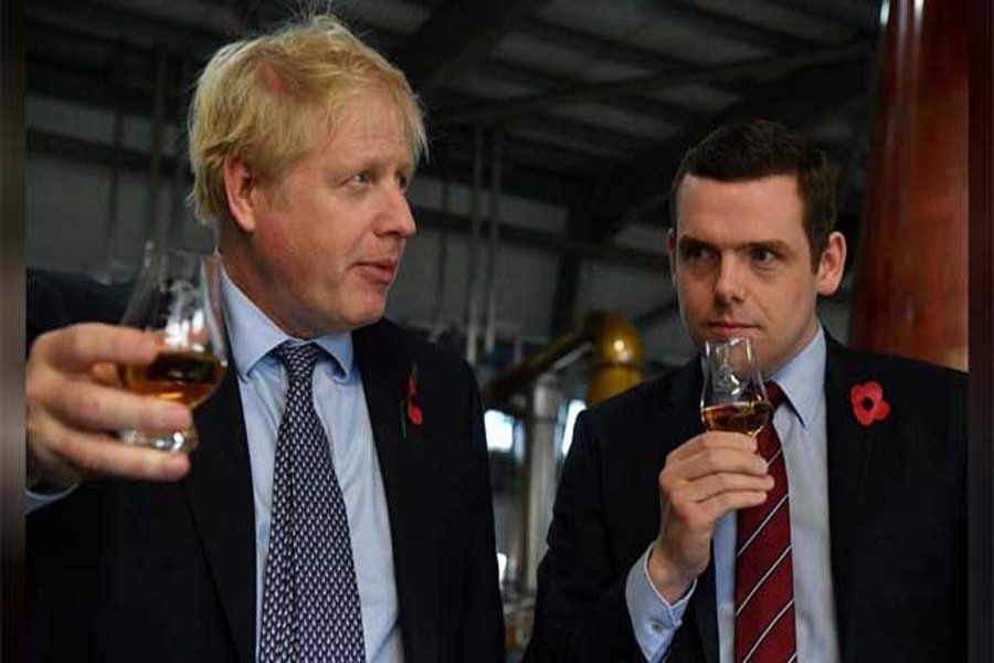 Britain's Prime Minister Boris Johnson, (L), accompanied by Conservative party candidate for Moray, Douglas Ross, tastes whisky during a general election campaign visit to Diageo's Roseisle Distillery near Elgin, Scotland, Britain Nov 7, 2019. REUTERS