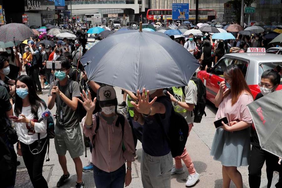 People wearing face masks take part in a protest against the second reading of a controversial national anthem law in Hong Kong, China May 27, 2020. REUTERS/Tyrone Siu