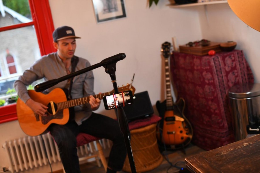 Musician Theo Bard sings as he performs an online gig from his kitchen, as the lockdown caused by the coronavirus disease (COVID-19) continues, in London, Britain May 18, 2020. Picture taken May 18, 2020. REUTERS/Dylan Martinez