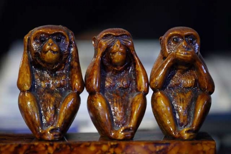 A sculpture of monkeys is pictured on the desk of Christian Sideris, founder of detective agency Seeclop, during an interview with Reuters amid the coronavirus disease (COVID-19) outbreak in Geneva, Switzerland April 28, 2020. REUTERS