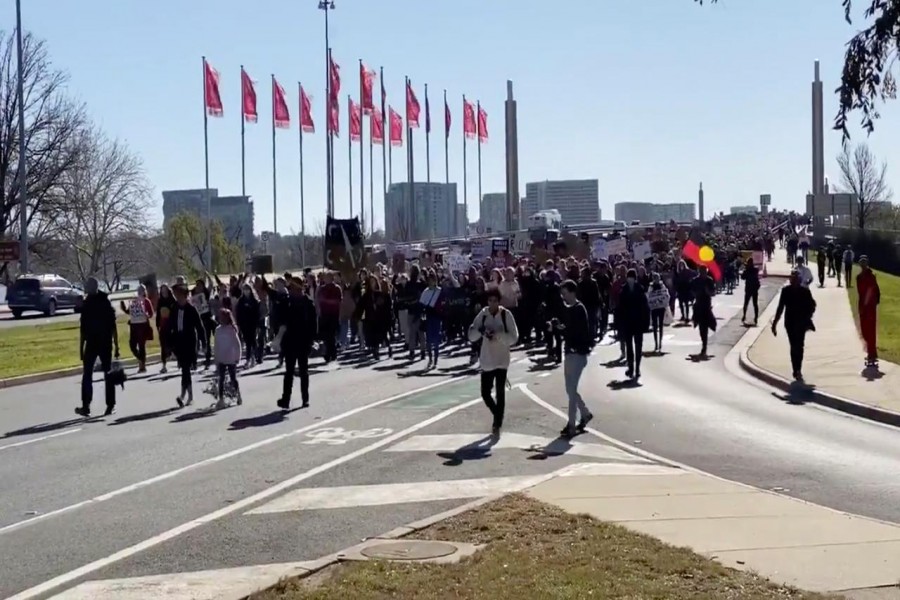 Demonstrators march to the Parliament House during a Black Lives Matter protest in Canberra, Australia, June 5, 2020 in this picture grab from a social media video. IAN MCKAY/via REUTERS