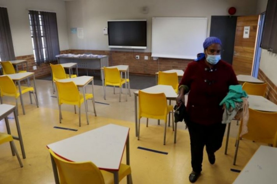 A worker walks past safely spaced desks following safe distancing measures amid the COVID-19 outbreak, at the Seshegong secondary school in Olivenhoutbosch, South Africa, May 28, 2020. /Reuters