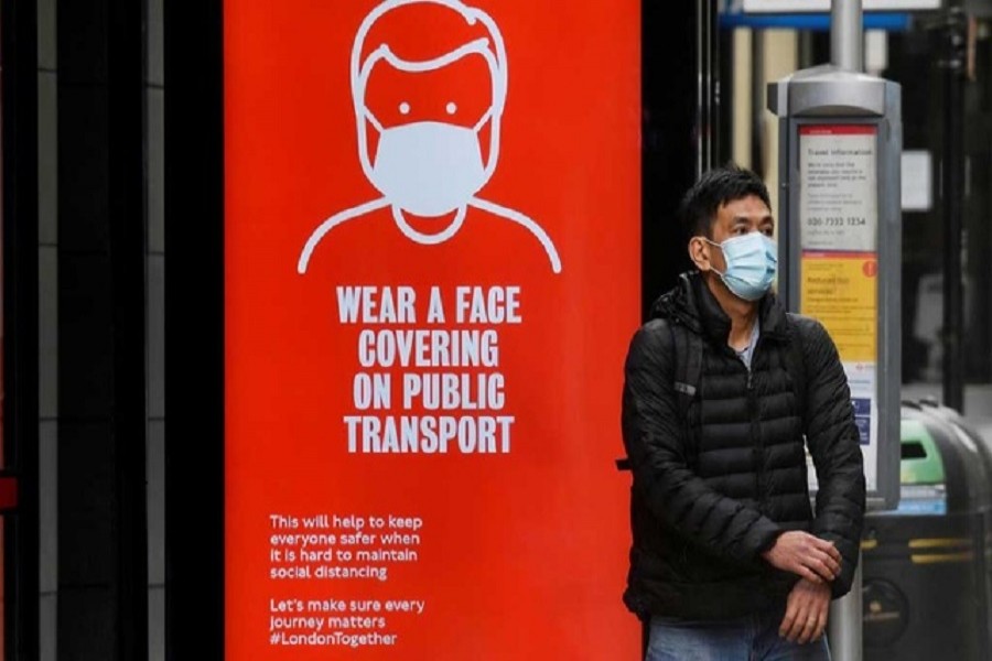 A man wearing a mask waits at a bus stop in London, following the outbreak of the coronavirus disease (Covid-19), London, Britain, June 05, 2020. — Reuters/Files