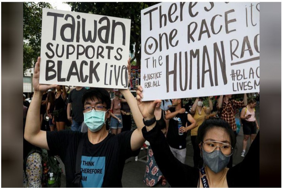 People hold posters supporting the Black Lives Matter Movement in Taipei, Taiwan, June 13, 2020. REUTERS/Ann Wang