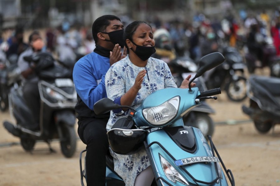 Faithful sit on their two-wheelers and pray as they attend a drive-in mass in an open area of Bethel AG Church as part of maintaining social distancing to prevent the spread of coronavirus in Bengaluru, India on Sunday, June 21, 2020 — AP photo