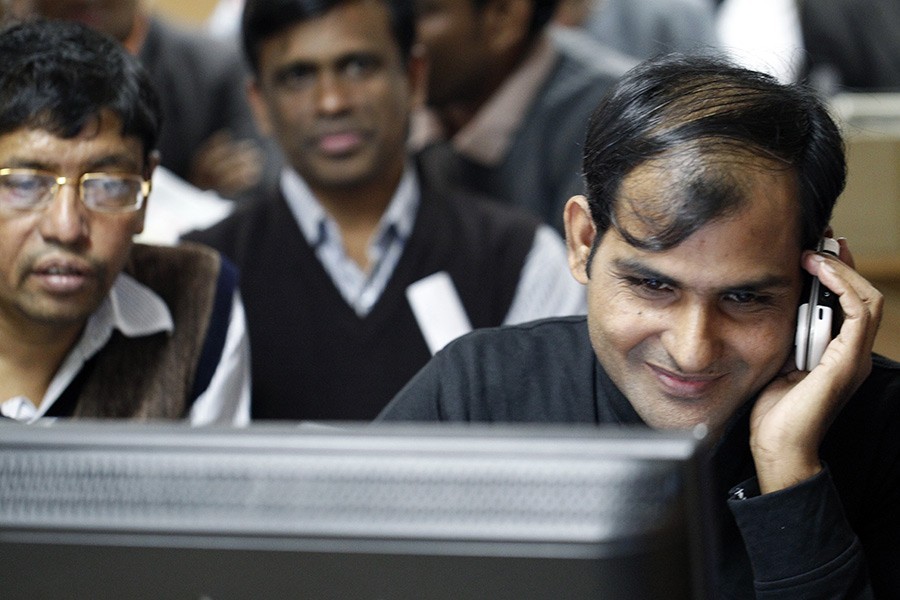Traders monitoring stock price movements on computer screens at a brokerage house in the capital city — FE/Files