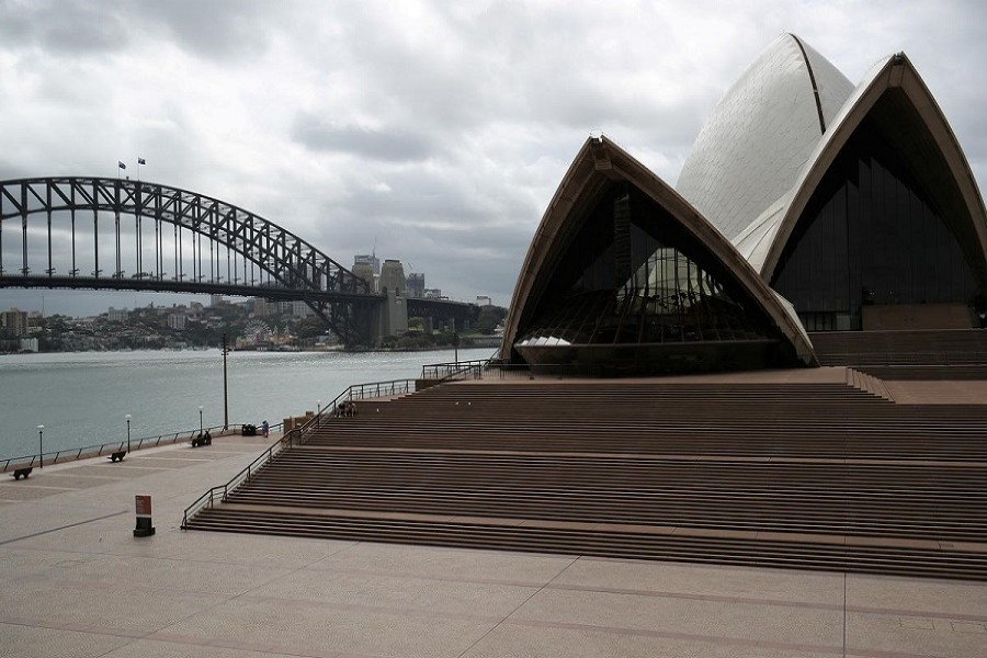 People are seen on the nearly deserted steps of the Sydney Opera House in Australia, March 26, 2020 — Reuters/Files