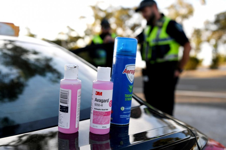Disinfectant products are seen on a car whilst motorists fill out paperwork for police as they cross back into South Australia from Victoria during the coronavirus disease (Covid-19) outbreak, in Bordertown, Australia on March 24, 2020 — Reuters/Files