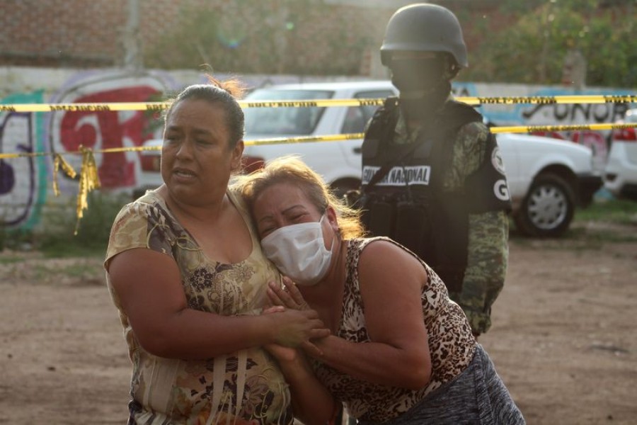 Women react outside a drug rehabilitation facility where assailants killed several people, according to Guanajuato state police, in Irapuato, Mexico July 1, 2020. REUTERS/Karla Ramos