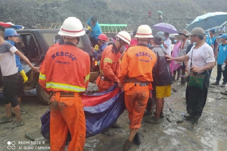Rescue workers carry a dead body following a landslide at a mining site in Hpakant, Kachin State City, Myanmar, July 02, 2020, in this picture obtained from social media — Myanmar Fire Services Department/via Reuters/File Photo