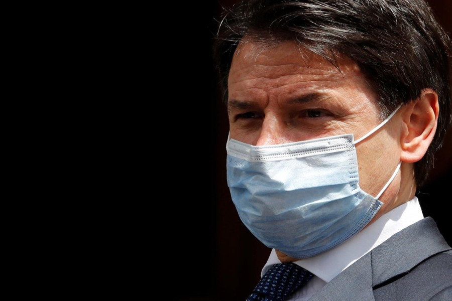 FILE PHOTO: Italian Prime Minister Giuseppe Conte wearing a protective face mask, leaves the Senate as the spread of the coronavirus disease (COVID-19) continues, in Rome, Italy May 20, 2020. REUTERS/Remo Casilli