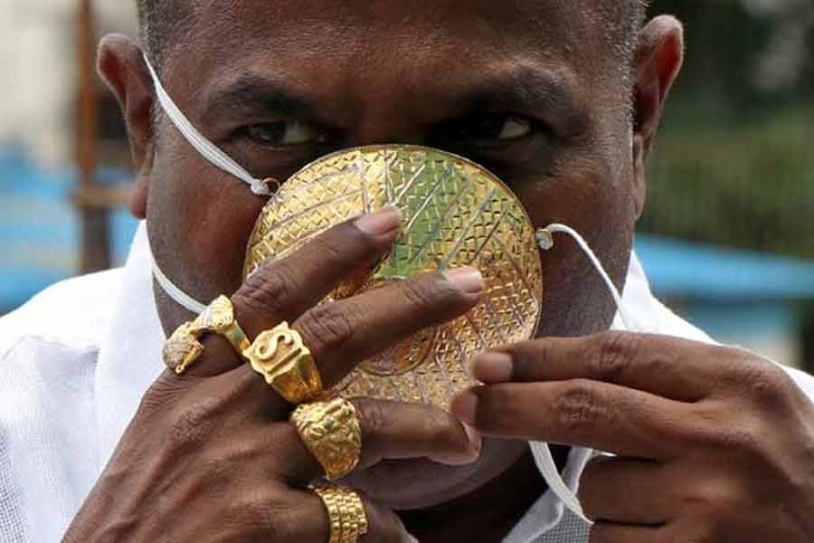 Shankar Kurhade posing a photograph with his face mask made out of gold as he poses for amidst the spread of the coronavirus disease (COVID-19) in Pune on Saturday –Reuters Photo