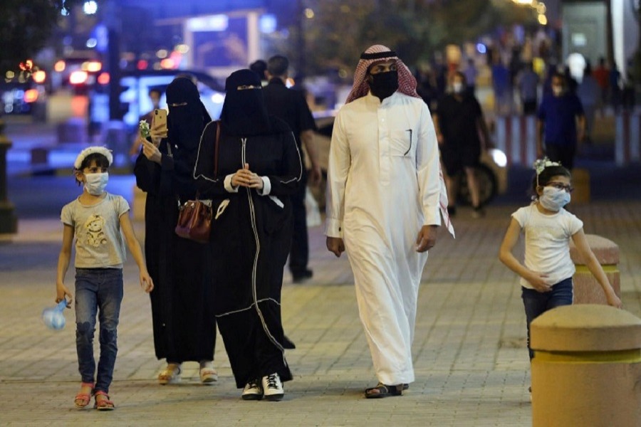 A Saudi family wearing protective face masks walk on Tahlia Street as nightlife kicks off, after the government loosened lockdown restrictions following the outbreak of the coronavirus disease (Covid-19), in Riyadh, Saudi Arabia, June 21, 2020 — Reuters