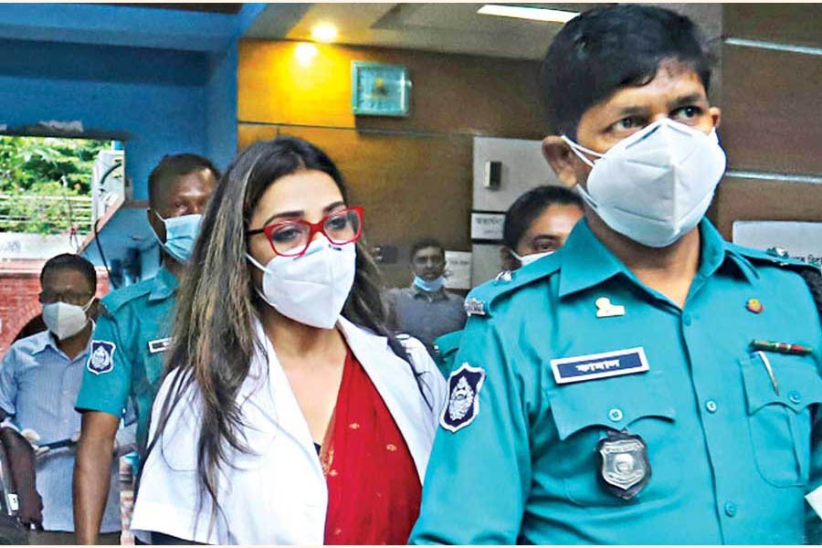 JKG Health Care’s Dr Sabrina Arif Chowdhury being taken away by police after interrogation at the Tejgaon DC office in Dhaka city on Sunday — Focus Bangla