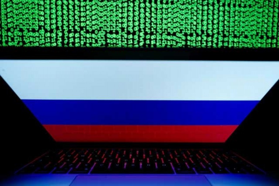 A Russian flag is seen on the laptop screen in front of a computer screen on which cyber code is displayed, in this illustration picture taken March 2, 2018. REUTERS