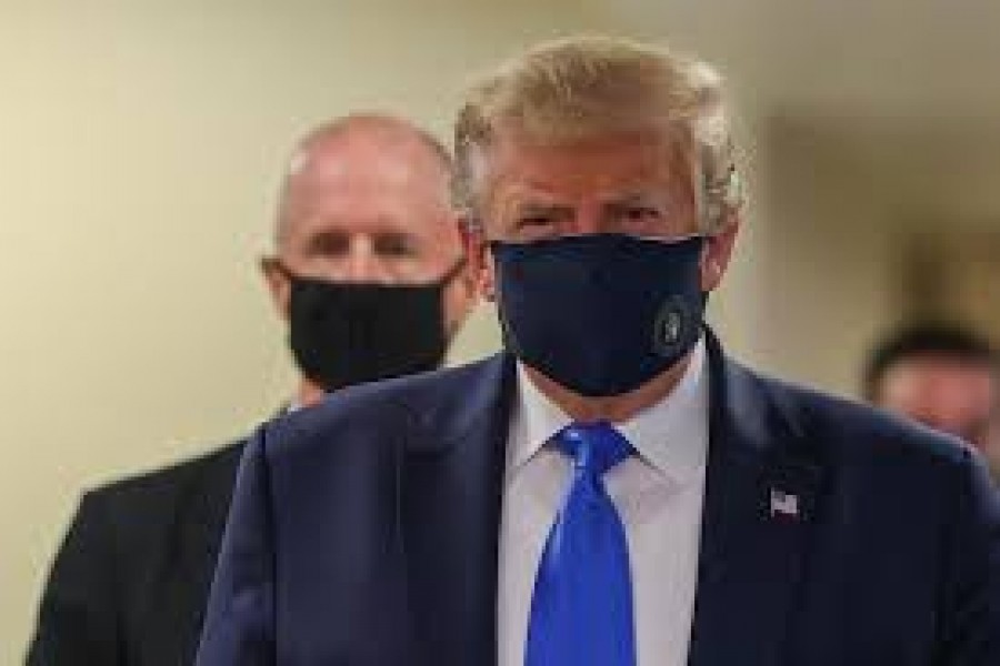 President Donald Trump, who has avoided wearing a mask in public even as the coronavirus pandemic spread, donned one on July 11 at a military medical facility outside Washington where he was to meet with wounded soldiers and front-line health-care workers.  -- Reuters photo